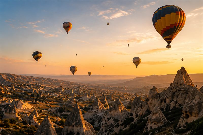 Hot air balloons rising over the Rajasthan countryside at sunrise